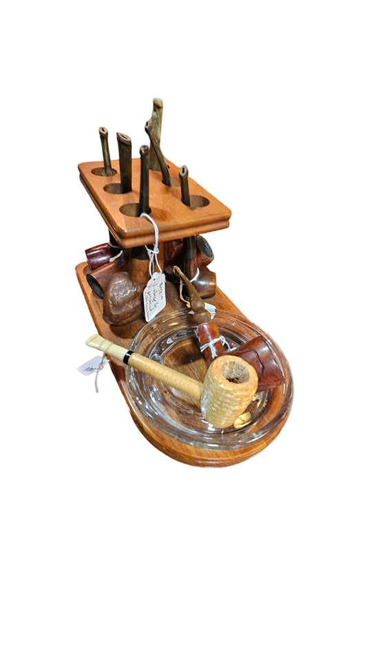 Wooden smoking accessory set with pipe, ashtray, and tools on a beige background